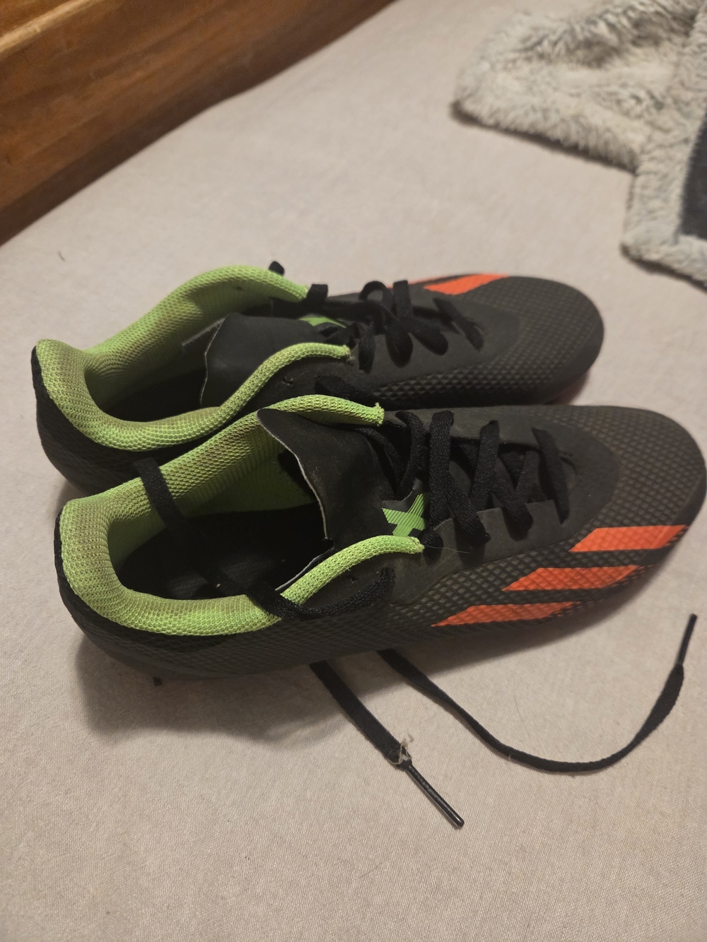 Adidas Black Cleats with Neon Green Lining and Orange Stripes